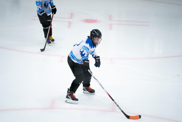 Skater stickhandles along the boards