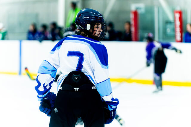 Teammates gather around the goalie